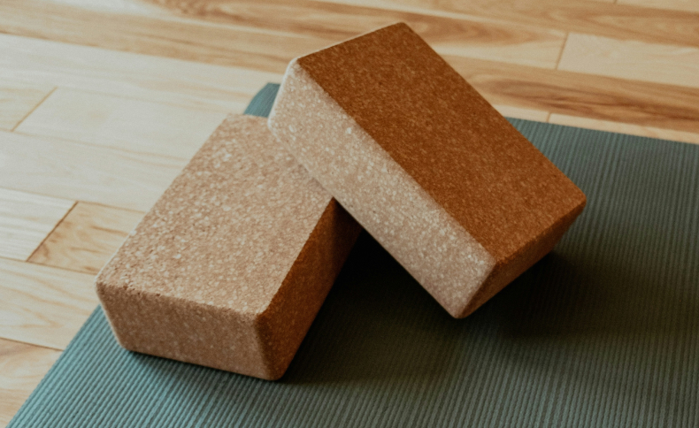 A stack of yoga blocks on a yoga mat.
